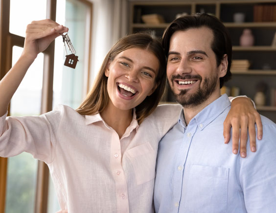 Pareja feliz con las llaves de su nueva casa